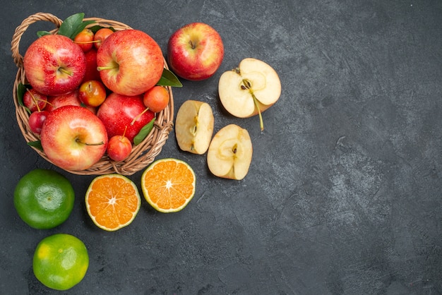 Top view from afar fruits apples citrus fruits wooden basket of apples cherries