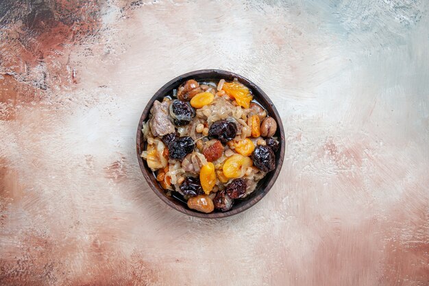 Top view from afar pilaf an appetizing pilaf in the bowl on the wooden table