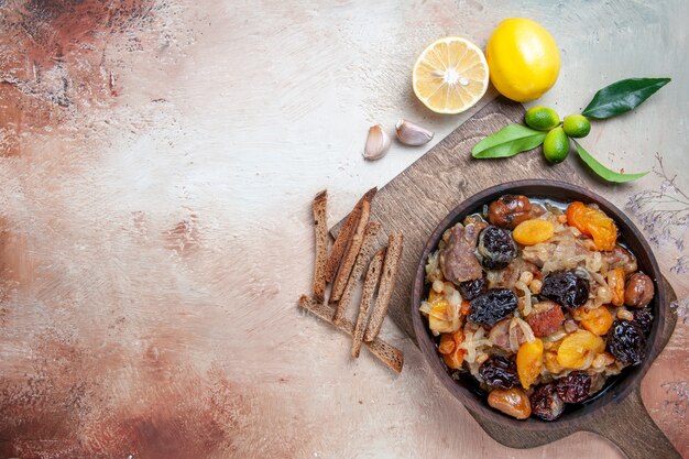 Top view from afar pilaf lemon garlic the wooden board with pilaf