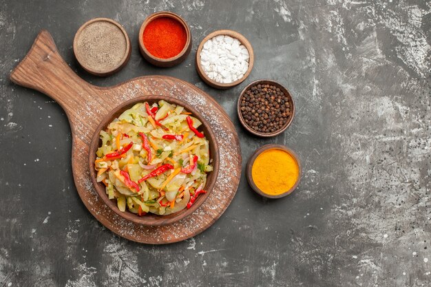 Top view from afar salad an appetizing vegetable salad on the board colorful spices