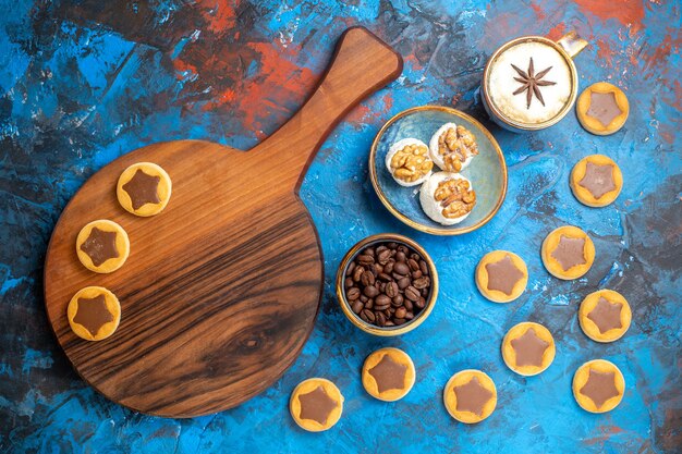 Top view from afar sweets coffee beans a cup of coffee Turkish delight cookies on the board