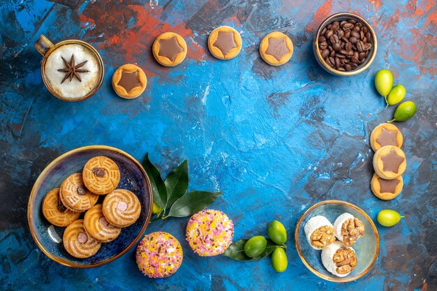 Top view from afar sweets different sweets cookies coffee beans a cup of coffee