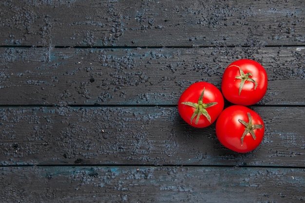 Top view from afar three tomatoes three ripe tomatoes on wooden table