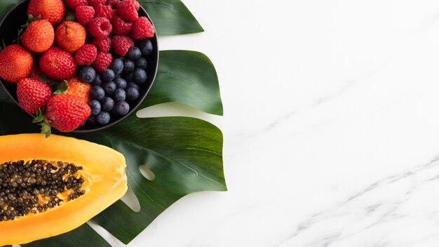 top view of fruit bowl with papaya and copy space