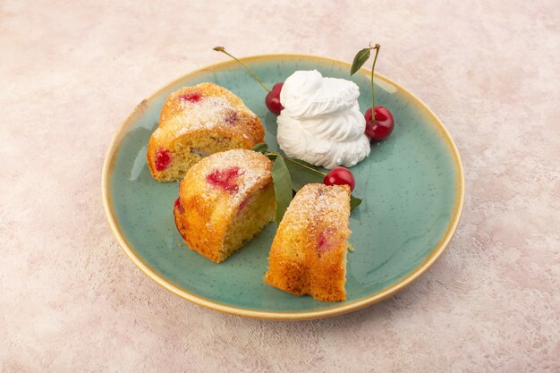 A top view fruit cake slices inside round plate on the pink table cake biscuit sugar sweet