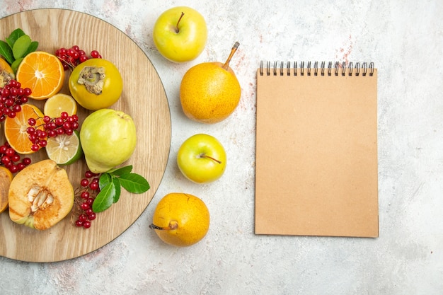 Top view fruit composition different fruits on a white table fresh ripe berry fruit