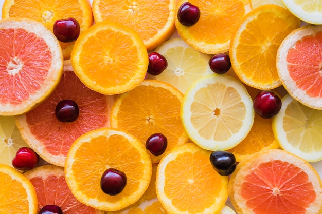 Top view of fruit slices with cherries