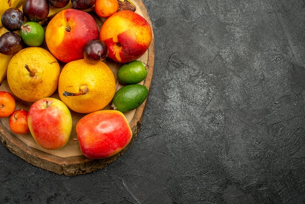 Top view fruits composition fresh fruits on dark grey background