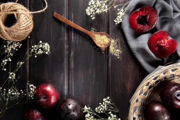 Free photo top view of fruits with basket and flowers