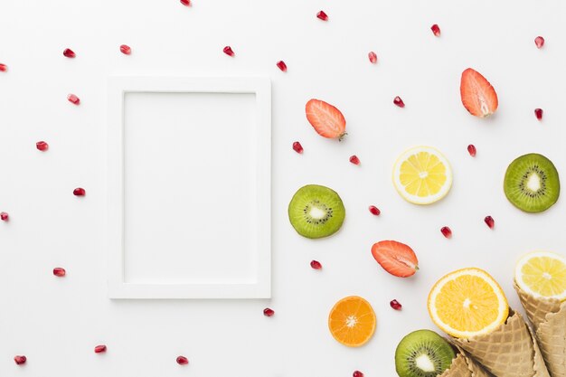 Free photo top view of fruits with cone and frame