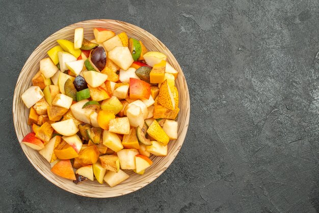 Top view of fruity salad with fresh sliced fruits