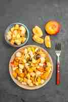 Free photo top view of fruity salad with fresh sliced fruits