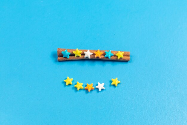 Top view ful sweet candies lined on blue background