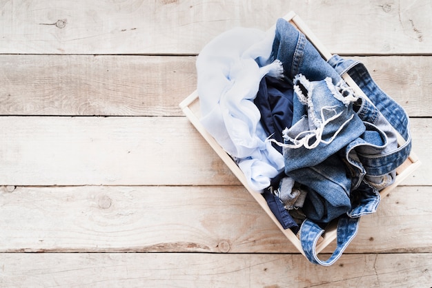 Top view full laundry basket with wooden background