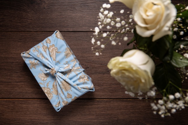 Free photo top view furoshiki package and flower