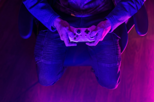 Free photo top view gamer holding controller