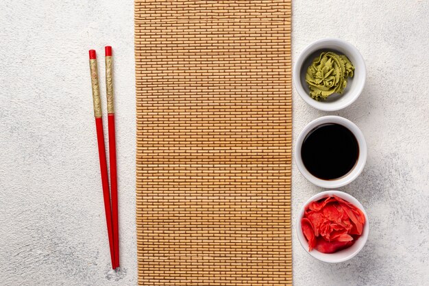 Top view ginger wasabi and soy sauce bowls with table cover