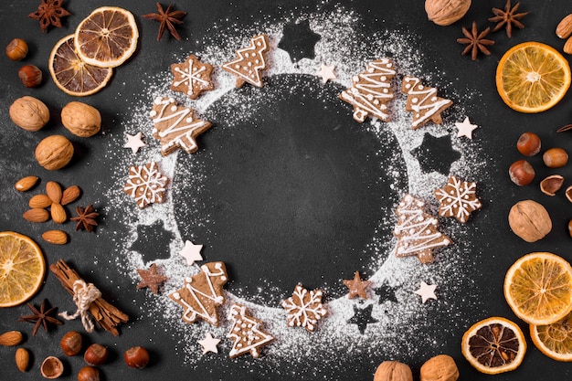 Top view of gingerbread cookies wreath with dried citrus and nuts