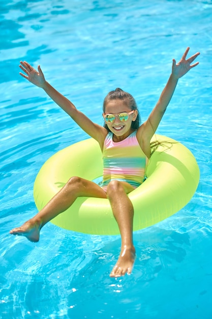 Top view of girl on inflatable ring on water