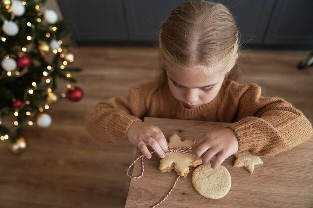 Top view of girl packing cookies for Santa Claus