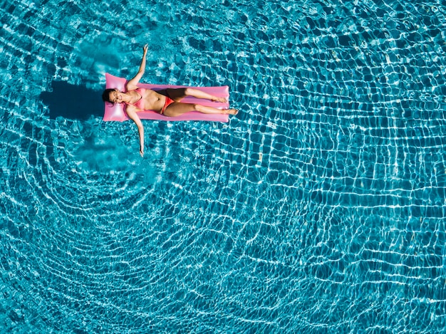 Top view of girl relaxing on inflatable mattress