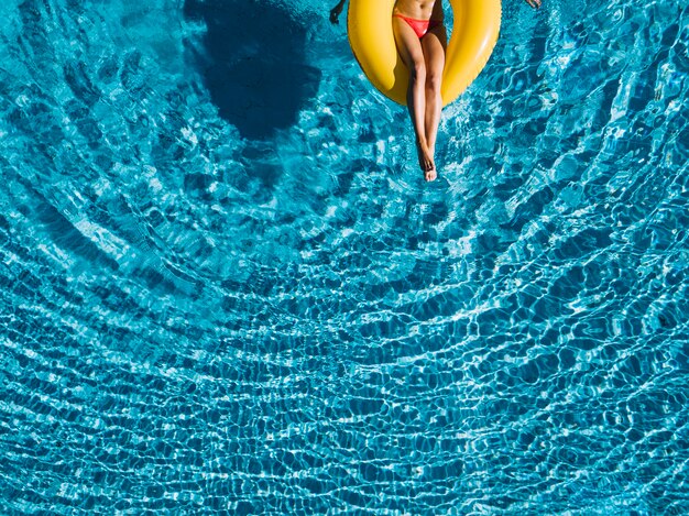 Top view of girl relaxing on inflatable ring