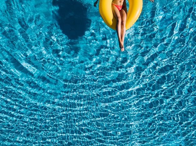 Top view of girl relaxing on inflatable ring