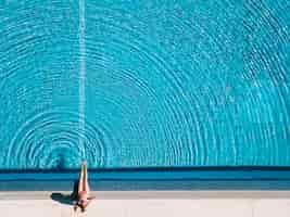 Free photo top view of girl relaxing next to pool