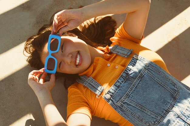 Top view girl wearing blue sunglasses