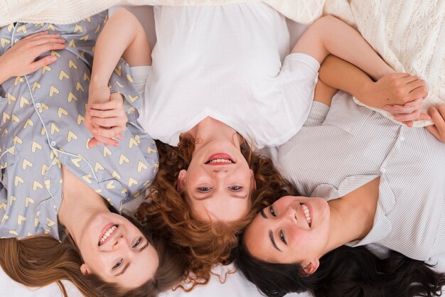 Top view girlfriends holding hands