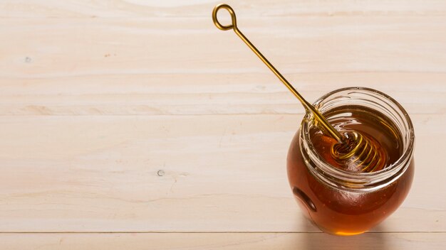 Top view glass jar full of honey