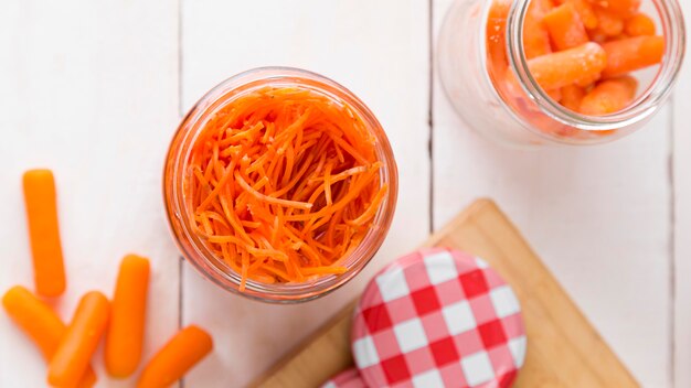 Top view of glass jar with chopped baby carrots