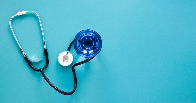 Top view glass of water with stethoscope on the table