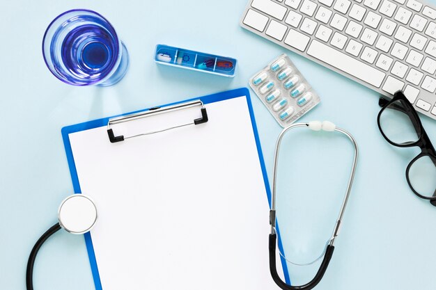 Top view glass of water with stethoscope