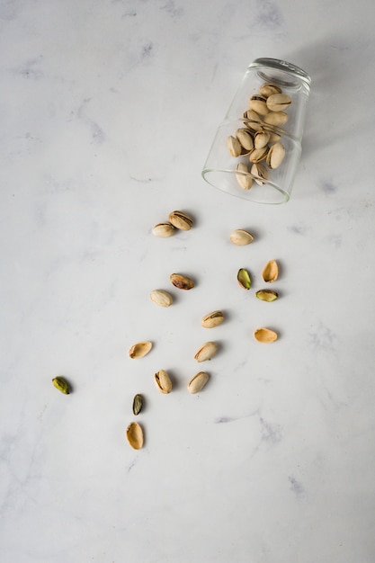 Free photo top view glass with pistachios