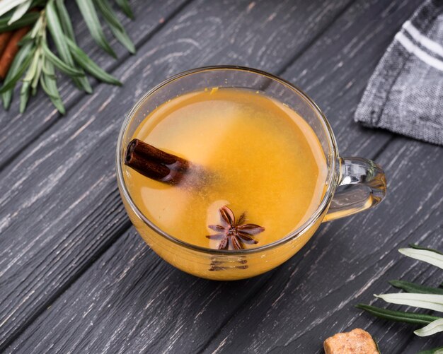 Top view glasses with flavored fruit juice and cinnamon