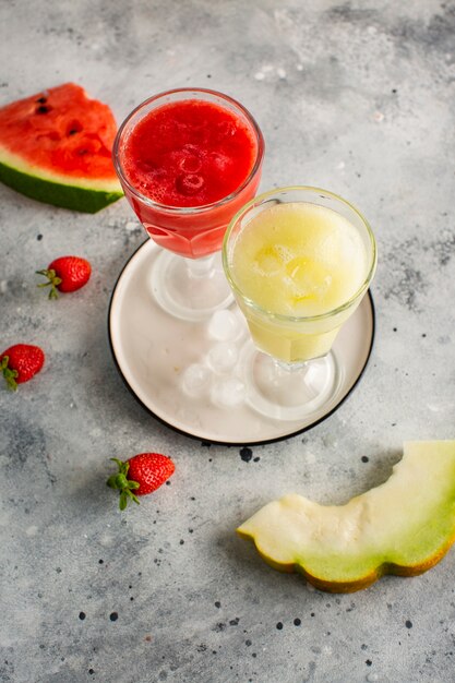 Top view glasses with red and yellow watermelon juice