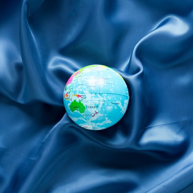 Top view of globe on blue satin