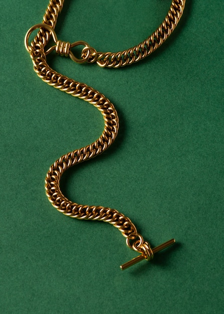 Top view gold chain on green background