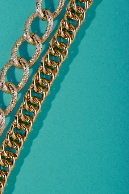 Top view on gold chains still life