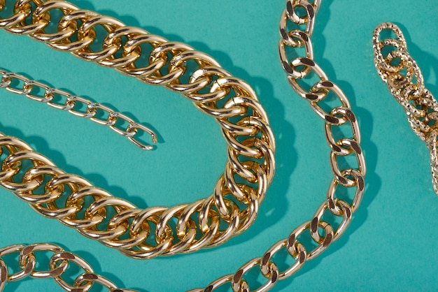 Top view on gold chains still life