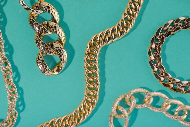 Top view on gold chains still life