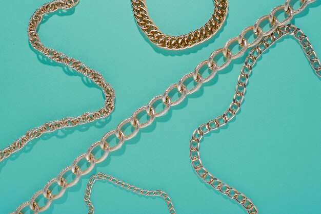 Top view on gold chains still life
