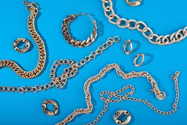 Top view on gold chains still life