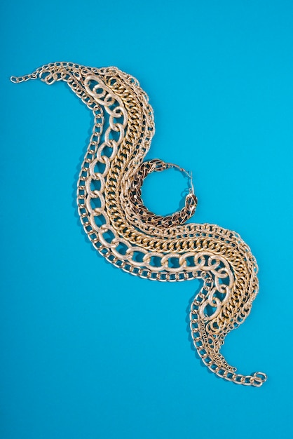 Top view on gold chains still life