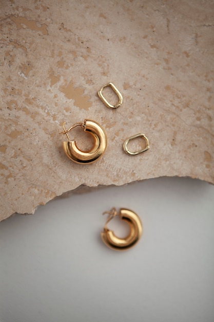 Top view golden earrings arrangement