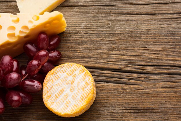 Top view gourmet cheese and grapes with copy space