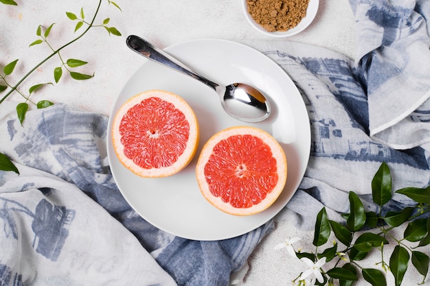 Top view of grapefruit on plate with spoon