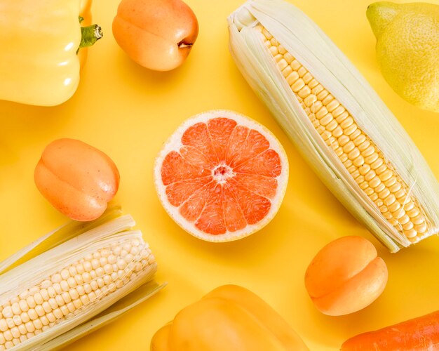 Top view of grapefruit with corn and peaches