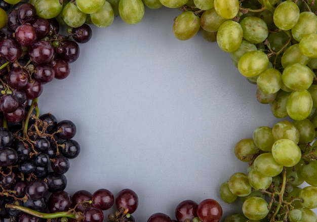 Top view of grapes set in round shape on gray background with copy space